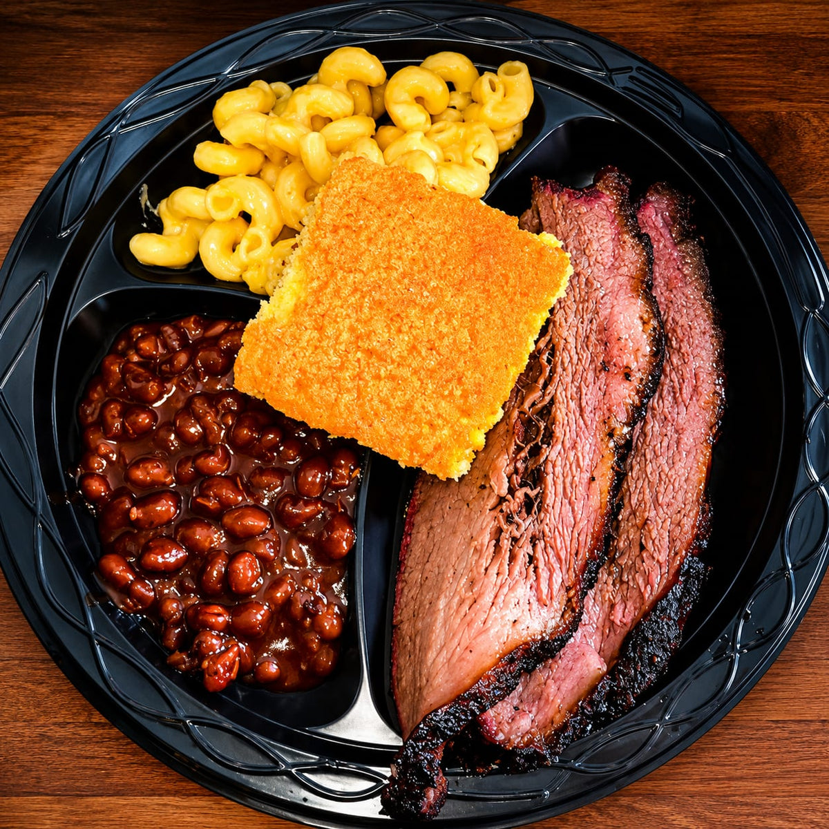 Brisket plate with baked beans, mac and cheese and cornbread
